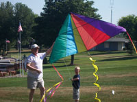 Ashburn back pain free grandpa and grandson playing with a kite